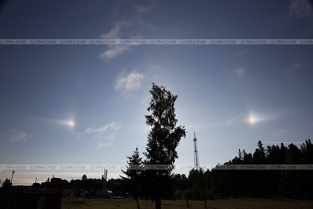 Sun dogs or parhelia caused by refraction of light from ice crystals in cirrus clouds