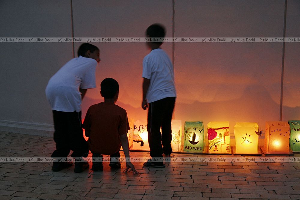 Hiroshima day 6 August memorial kids looking at the paper lanterns with candles inside