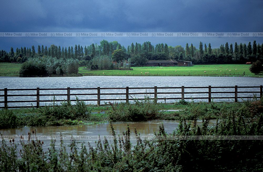 River Ouzel in flood with dramatic storm cloud, Walton Hall, Milton Keynes