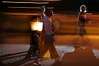 Hiroshima day 6 August memorial buddhist monks and crowd carrying lit paper lanterns towards the lake
