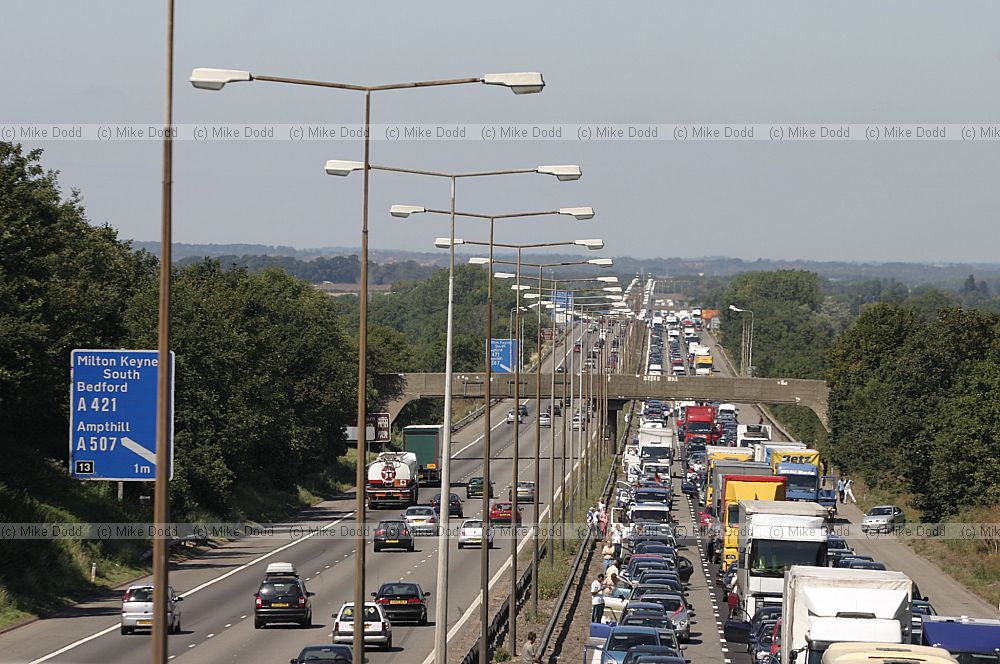 Traffic chaos on M1 after accident and Lorry fire.  The motorway surface has to be relayed resulting in a several hour delay for motorists.  Junctions were closed by the police