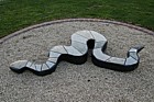 Viper sniper sculpture by Dominic Benhura in springstone and opal stone at Open University Walton Hall