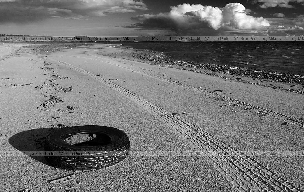 Tyre and tracks on the beach