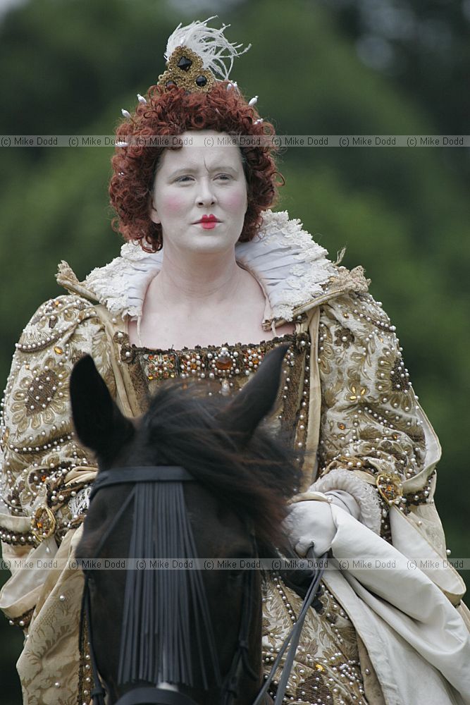 Queen Elizabeth I riding on a horse at a historical re-enactment