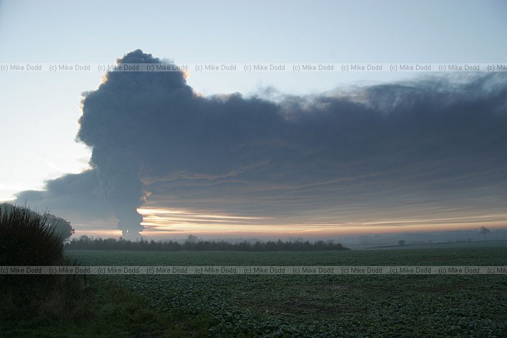 Huge fire at Buncefield oil storage depot Hemel Hempstead picture taken at dawn showing vast plume of smoke some shots with fireball too