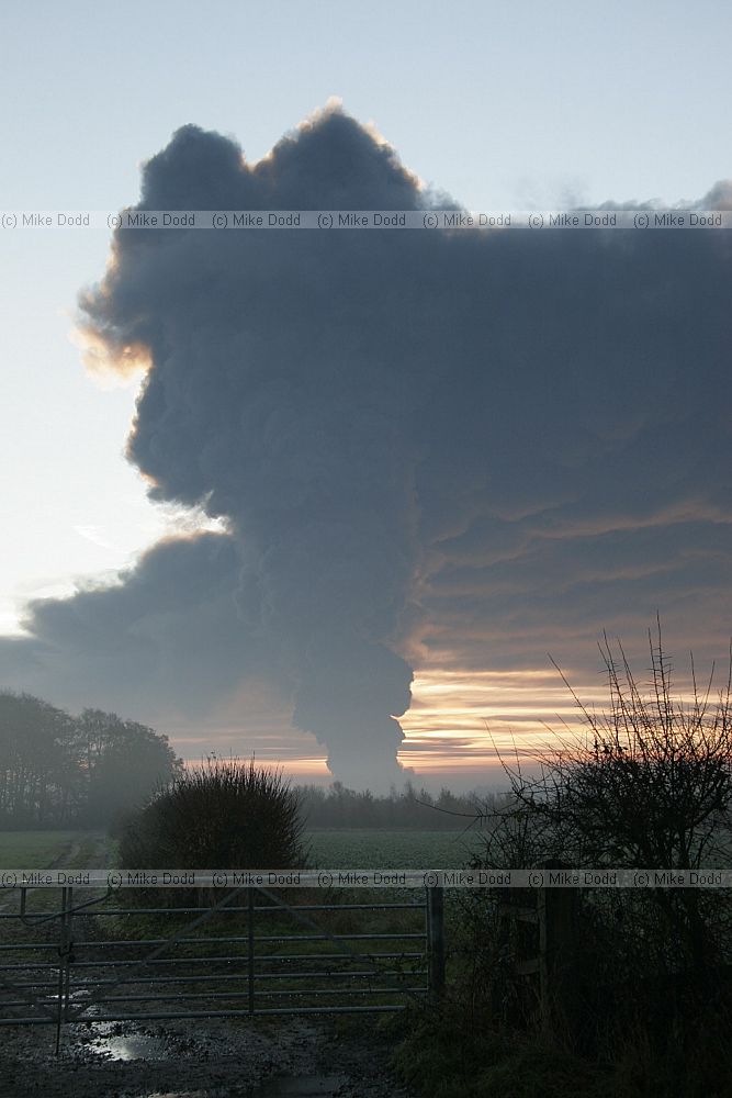 Huge fire at Buncefield oil storage depot Hemel Hempstead picture taken at dawn showing vast plume of smoke some shots with fireball too