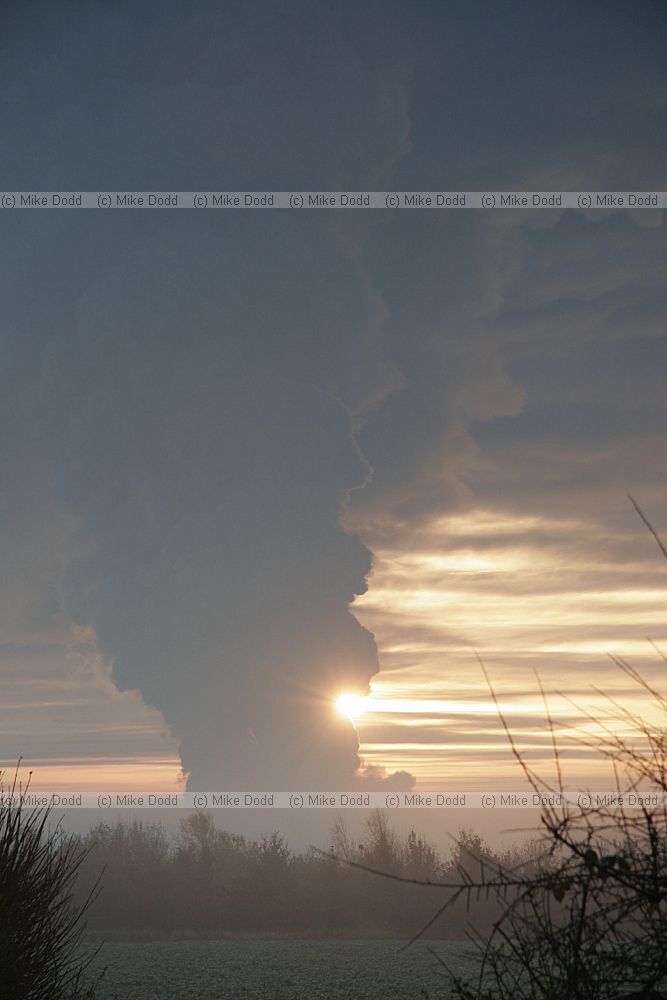 Huge fire at Buncefield oil storage depot Hemel Hempstead picture taken at dawn showing vast plume of smoke some shots with fireball too