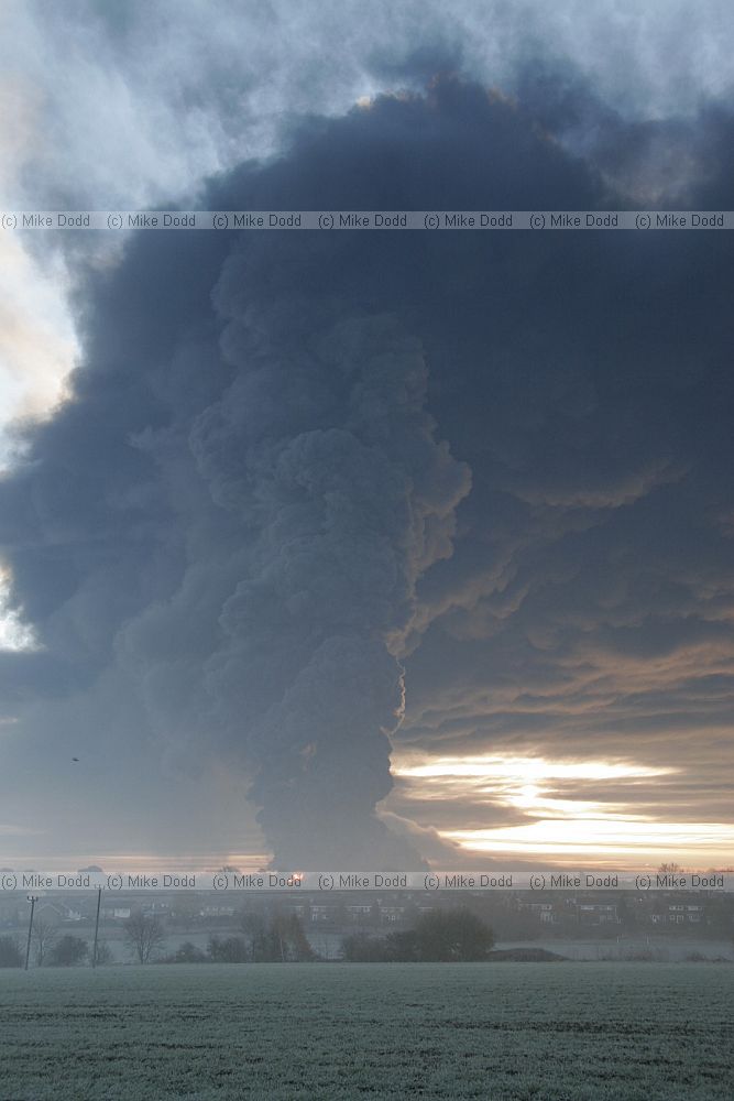 Huge fire at Buncefield oil storage depot Hemel Hempstead picture taken at dawn showing vast plume of smoke some shots with fireball too