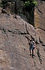 Climber on millstone grit rock Hathersage Peak District