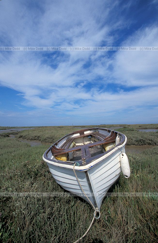 White boat on saltmarsh Norfolk and cirrus clouds