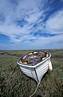 White boat on saltmarsh Norfolk and cirrus clouds
