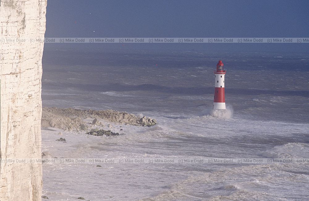 Stormy sea and waves with lighthouse at Beachy head