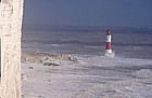Stormy sea and waves with lighthouse at Beachy head