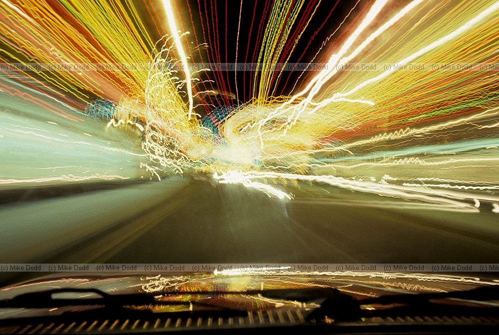 Christmas lights in street taken from moving car artistic