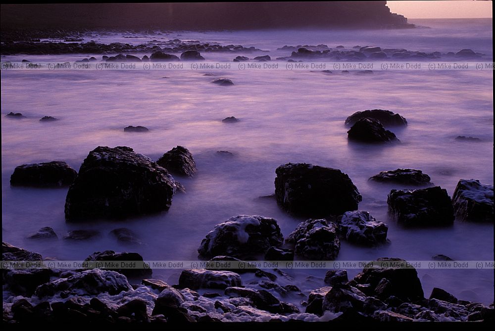 Sunset with rough sea giant's causeway northern Ireland