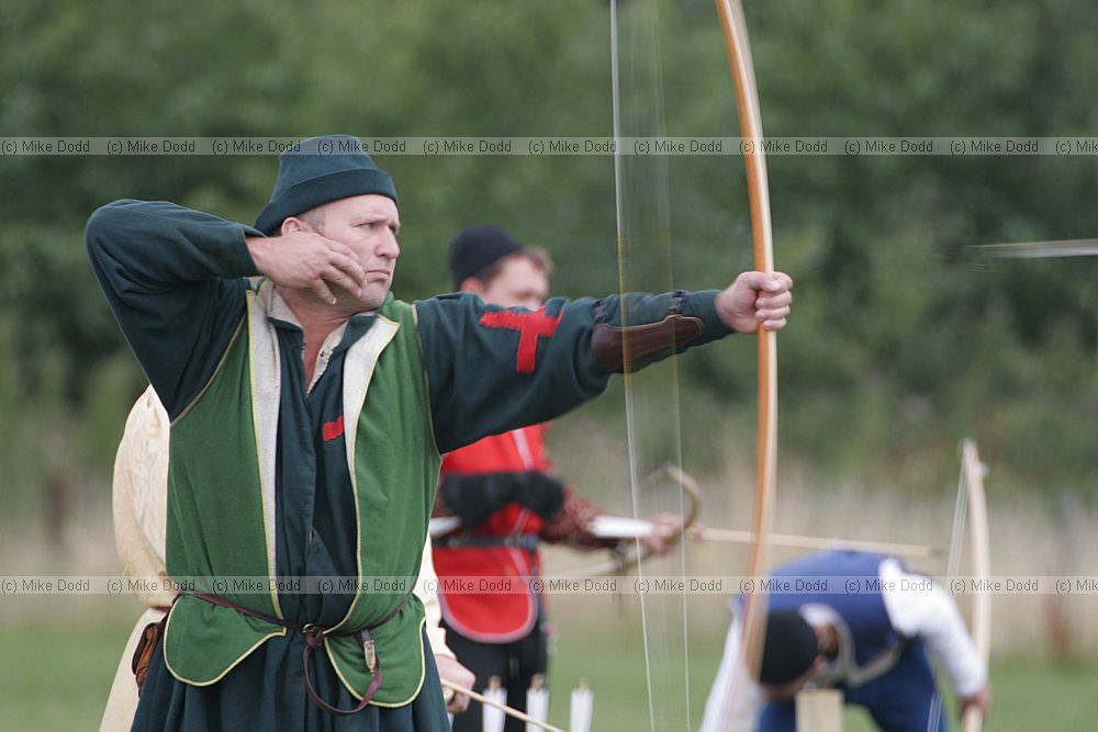 Archer firing arrow at Knight's contest