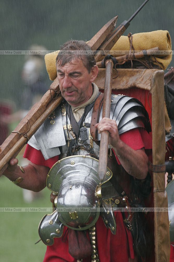 Roman army legionary on the march carrying full kit in the rain