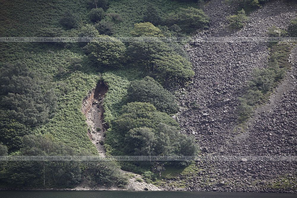 Erosion on hillside stream cutting into steep hillside