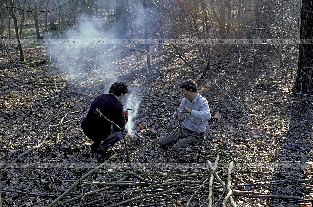 Conservation volunteers lighting fire in forest