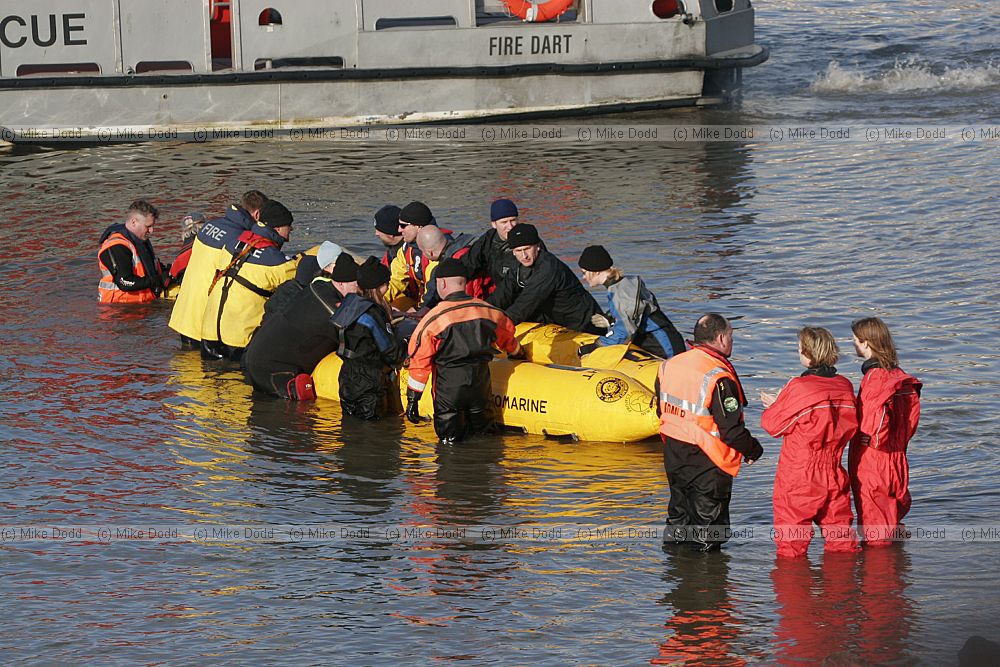 Rescuers trying to save northern bottle nosed whale in river Thames at Battersea.  Police fireservice and British Divers Marine Life Rescue organisation taking part.