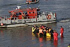 Rescuers trying to save northern bottle nosed whale in river Thames at Battersea.  Police fireservice and British Divers Marine Life Rescue organisation taking part.