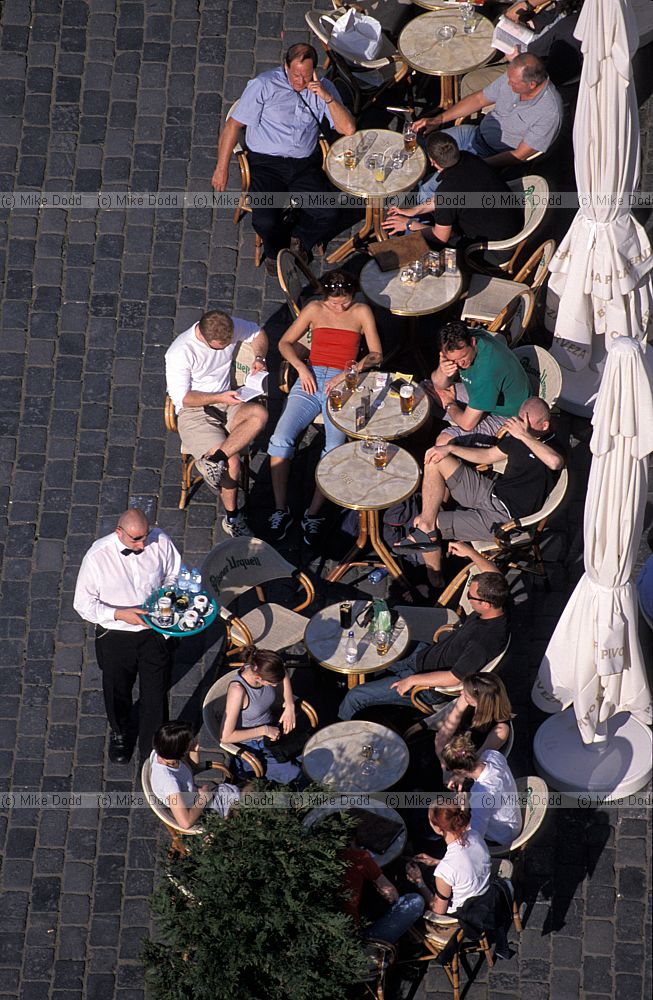 People sitting outside cafe Old town square (Staromestske Namesti) Prague