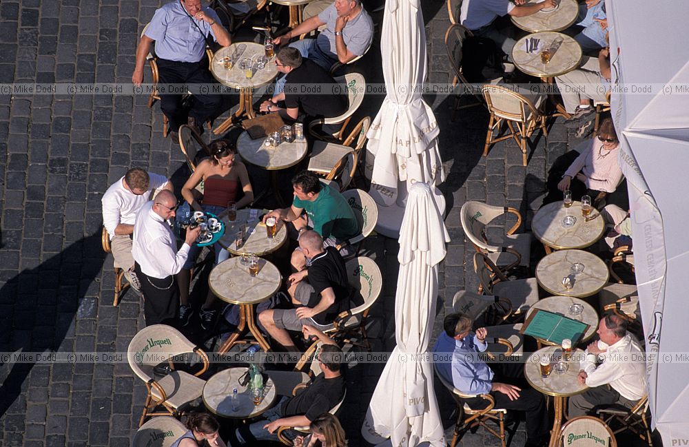 People sitting outside cafe Old town square (Staromestske Namesti) Prague