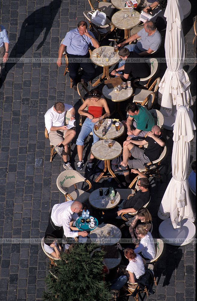 People sitting outside cafe Old town square (Staromestske Namesti) Prague