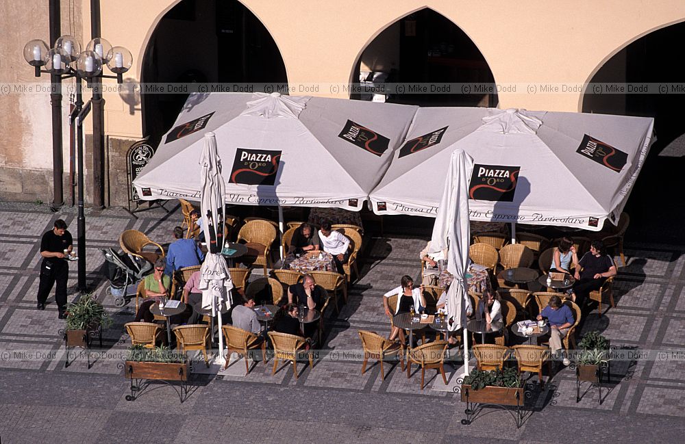 People sitting outside cafe Old town square (Staromestske Namesti) Prague