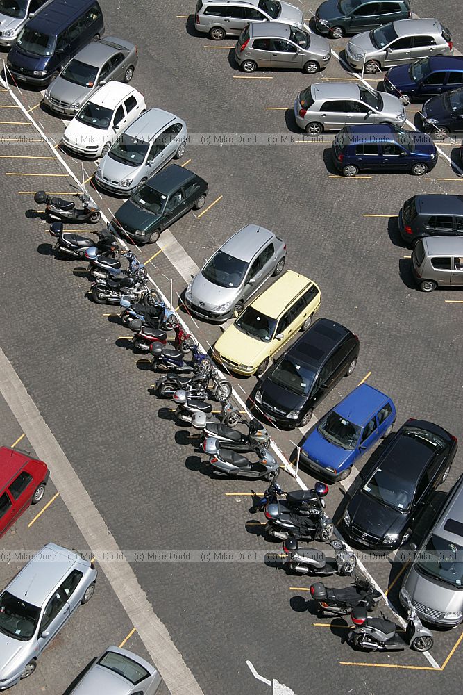 cars and motorbikes scooters parked in Vatican city Rome