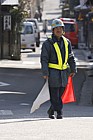 Person directing traffic with flags at roadworks