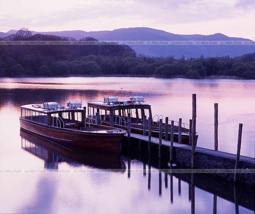 Boats by pier Derwentwater sunset Lake District