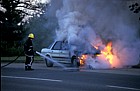 Fireman, burning car at Willen, flames and smoke, Milton Keynes