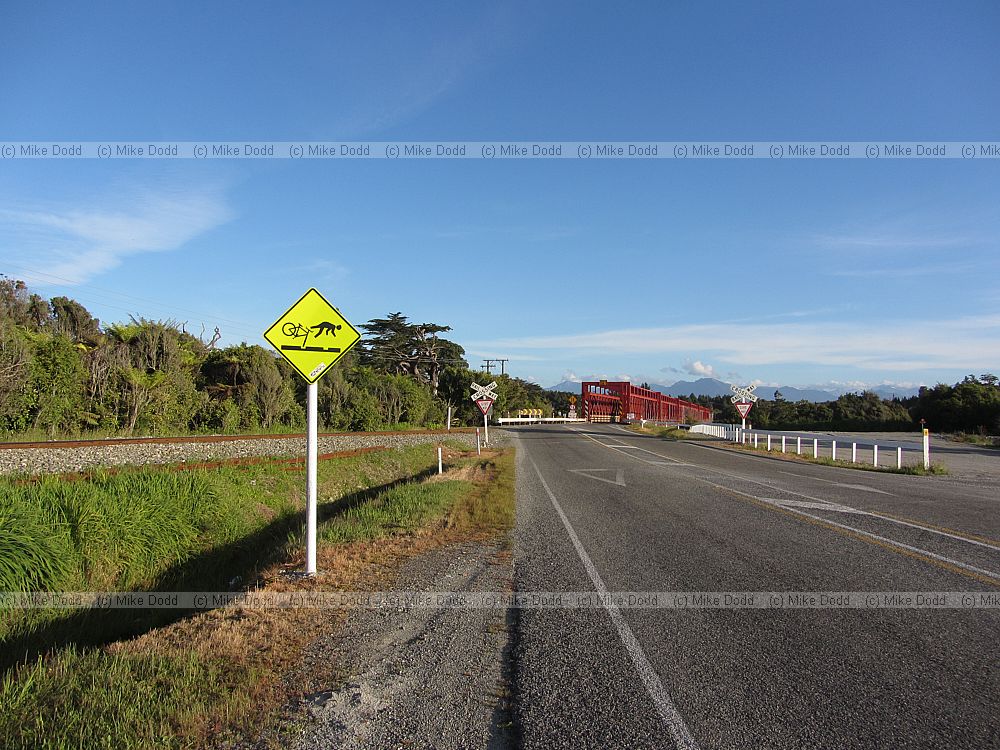 Cyclist falling off bike roadsign