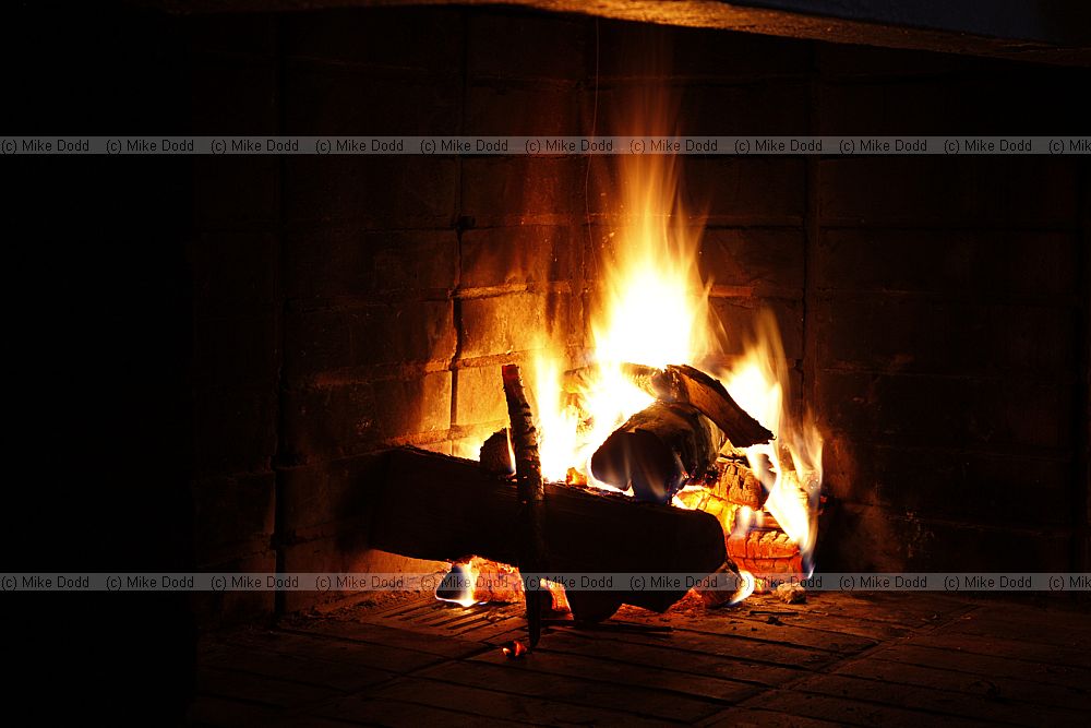Fireplace in the games room with fire burning in grate