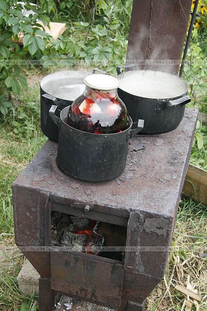 outdoor stove heating pans of water for preserving fruit and veg
