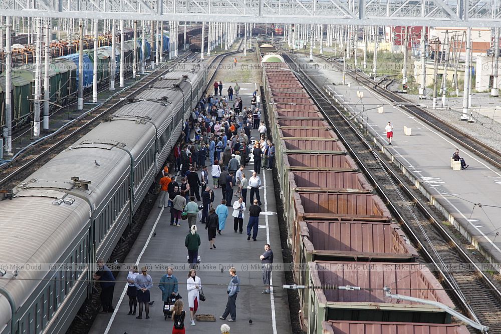 People on platform buying goods from local traders and waiting for train to go
