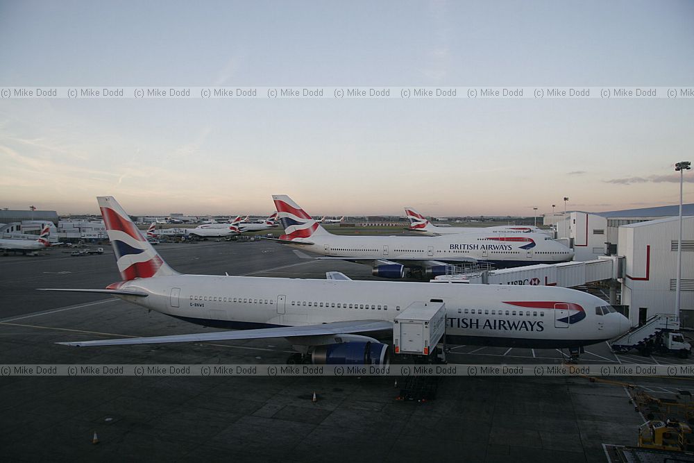 British Airways planes at Heathrow airport London lined up in the evening