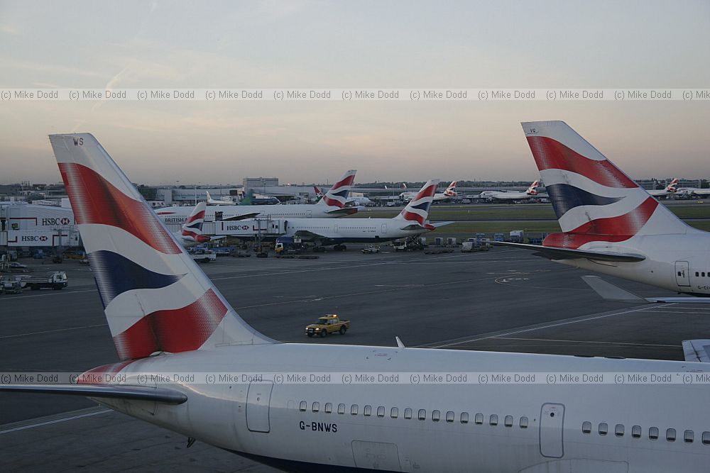 British Airways planes at Heathrow airport London lined up in the evening