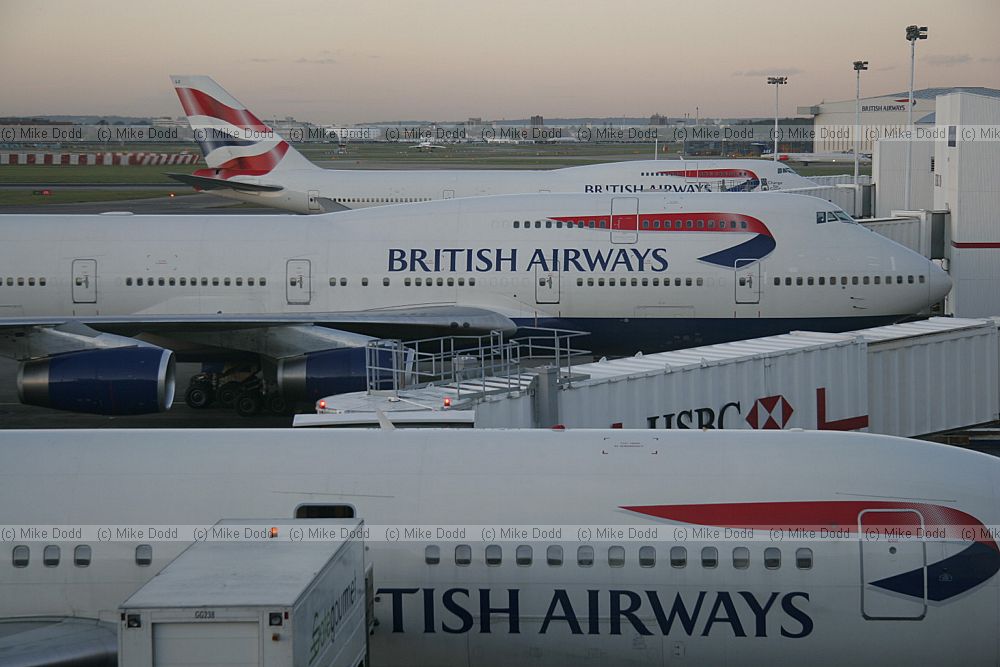 British Airways planes at Heathrow airport London lined up in the evening