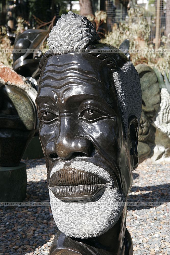 Selling stone sculptures on roadside near Scarborough Cape peninsula