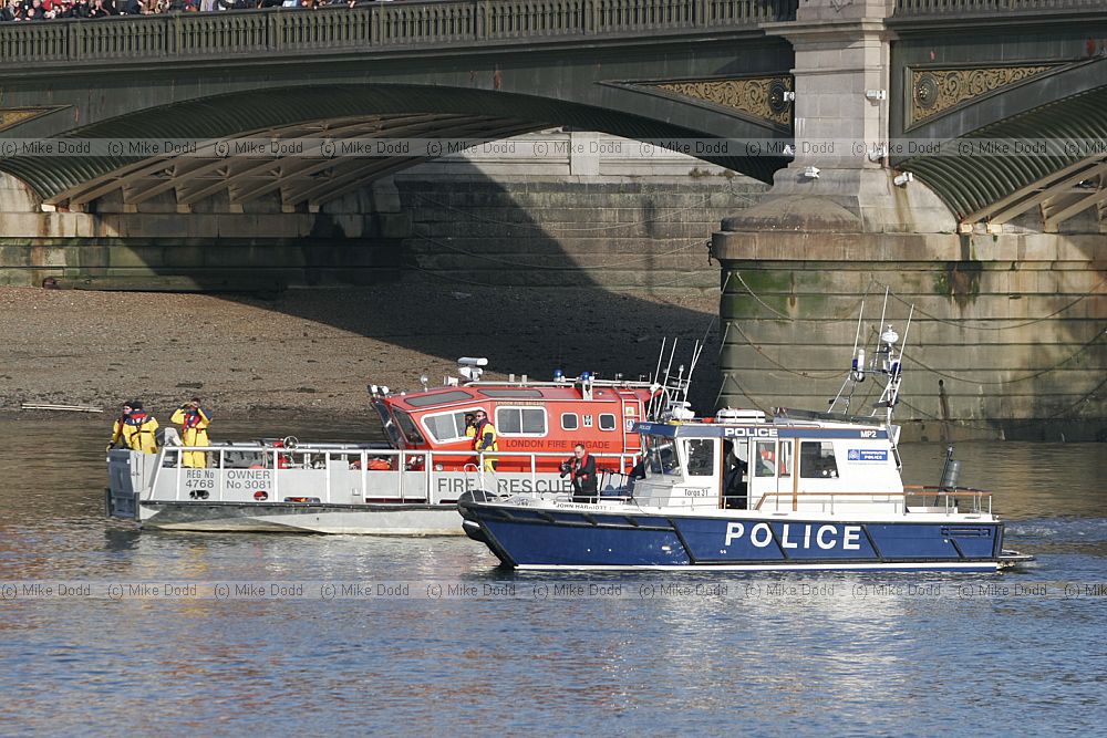 Fireboat and police launch Battersea bridge river Thames London