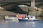 Fireboat and police launch Battersea bridge river Thames London