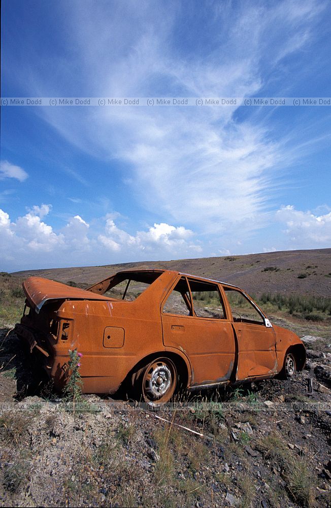 Derelict cars on slag heap Merthyr Tydfil