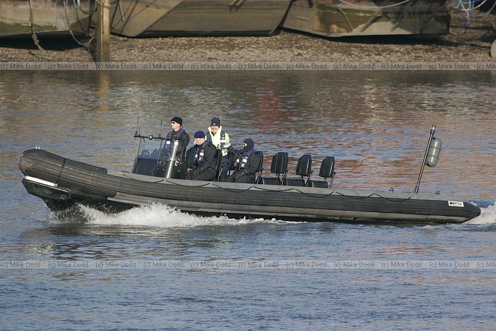Police zodiac large black rubber boat river Thames