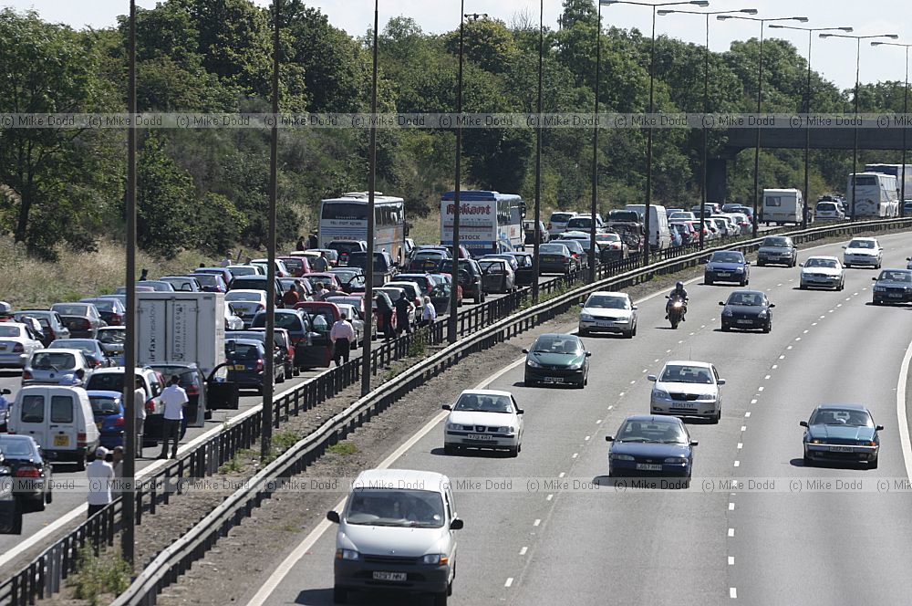 Traffic chaos on M1 after accident and Lorry fire.  The motorway surface has to be relayed resulting in a several hour delay for motorists.  Junctions were closed by the police
