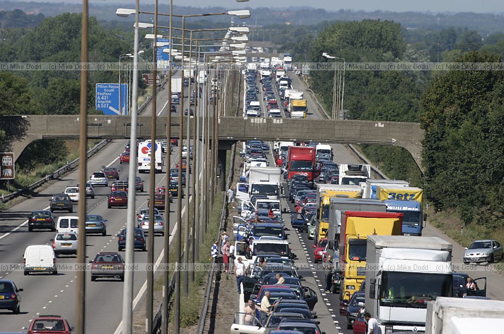 Traffic chaos on M1 after accident and Lorry fire.  The motorway surface has to be relayed resulting in a several hour delay for motorists.  Junctions were closed by the police