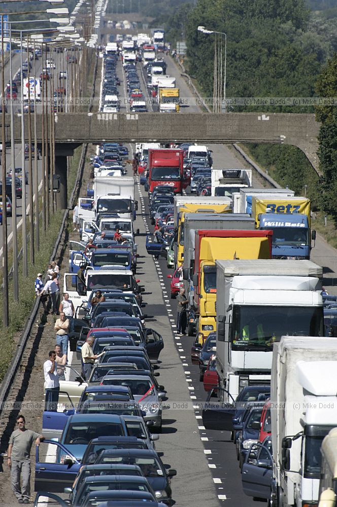 Traffic chaos on M1 after accident and Lorry fire.  The motorway surface has to be relayed resulting in a several hour delay for motorists.  Junctions were closed by the police