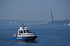 Police boat and Statue of Liberty New York