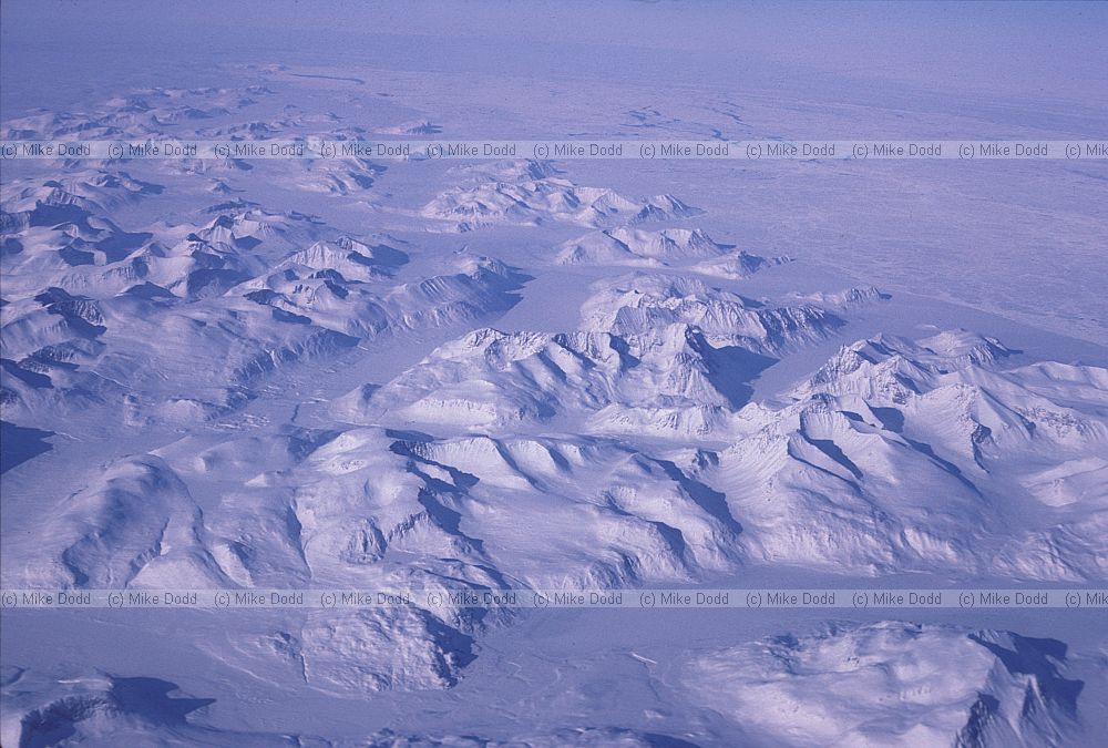 Newfoundland or Greenland snowy mountains from plane